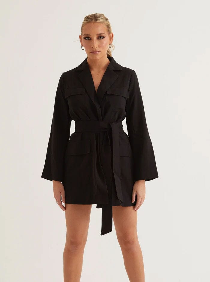 Woman wearing a black long-sleeve blazer dress