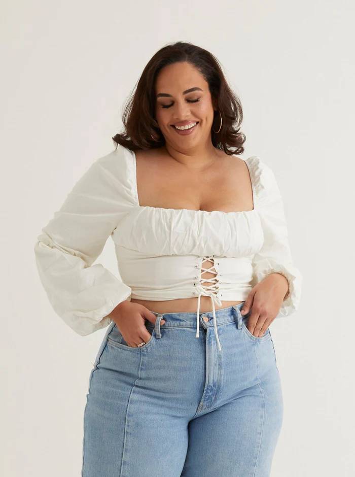 Woman wearing a white ruched off-the-shoulder top