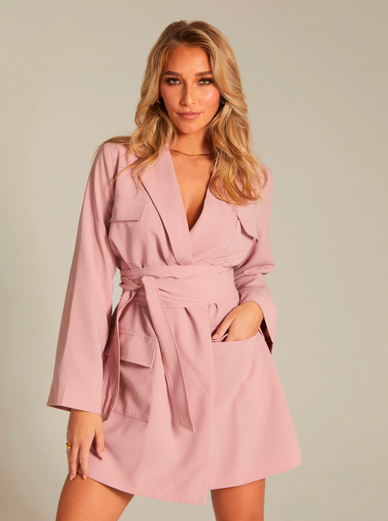 A woman in a blush-colored blazer dress