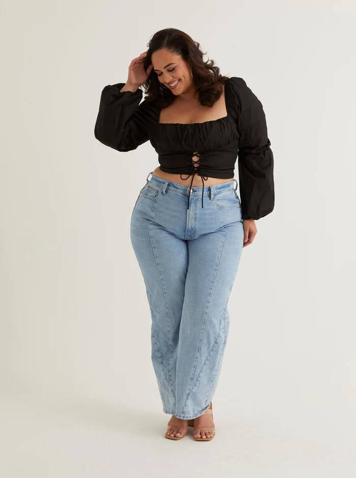 Woman wearing a black corset puff sleeve top