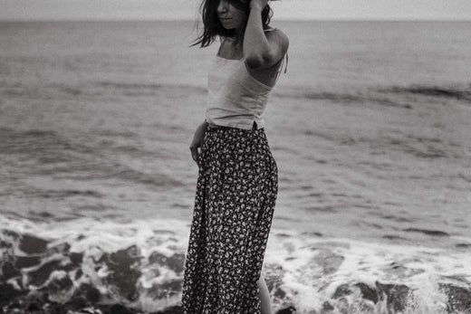 A woman at the beach dressed in a maxi skirt