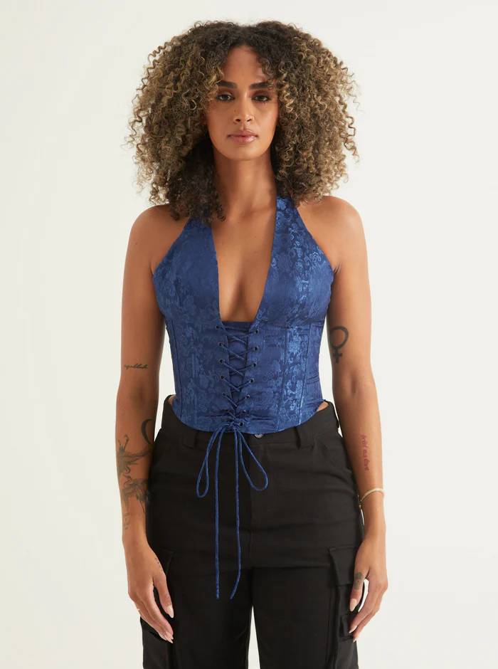 A model wearing a blue corset women’s date night top