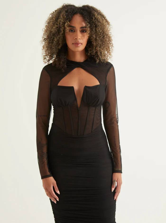 Woman wearing a black corset midi dress
