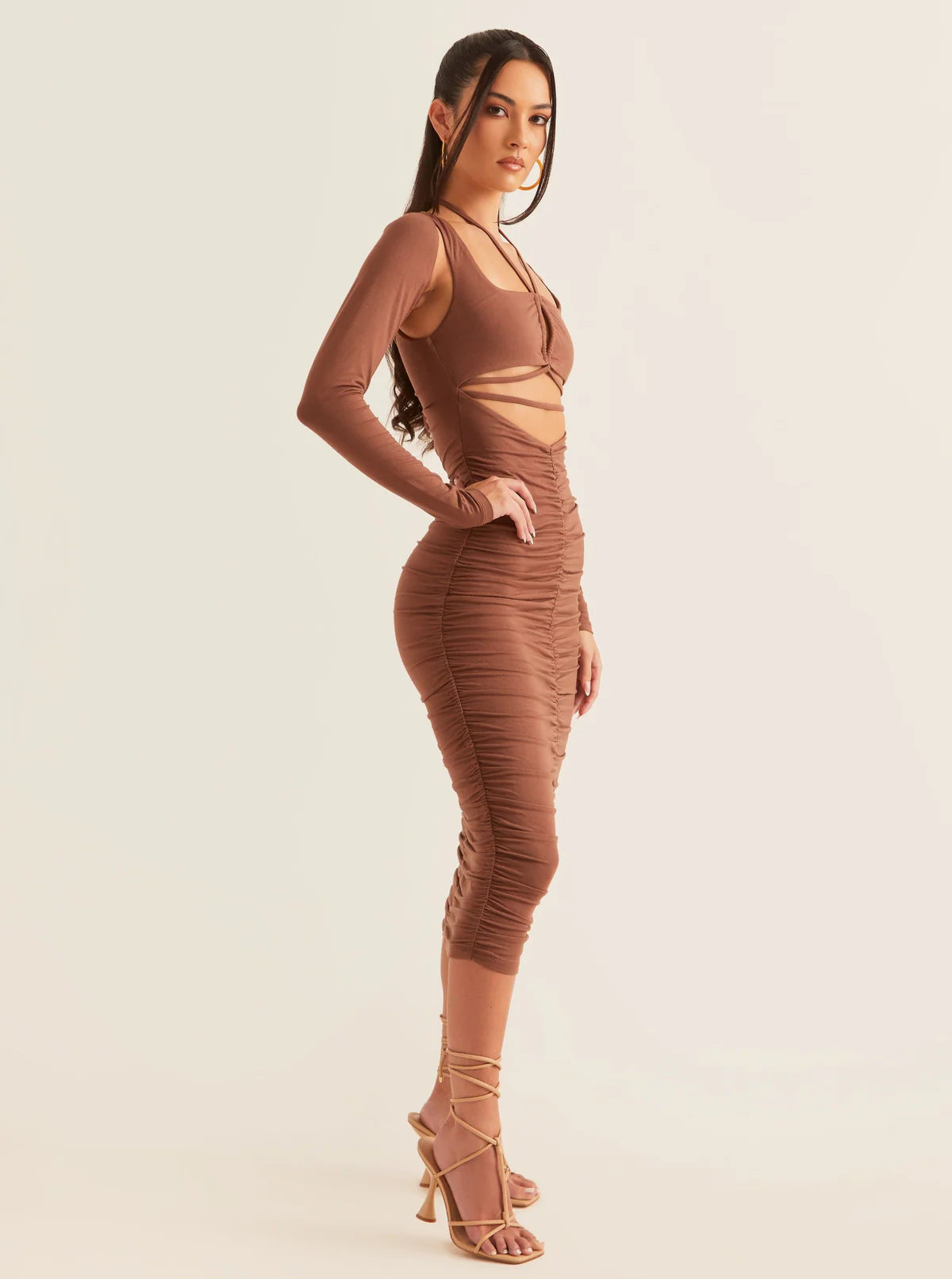 A model wearing a midi-length women’s going-out dress in brown