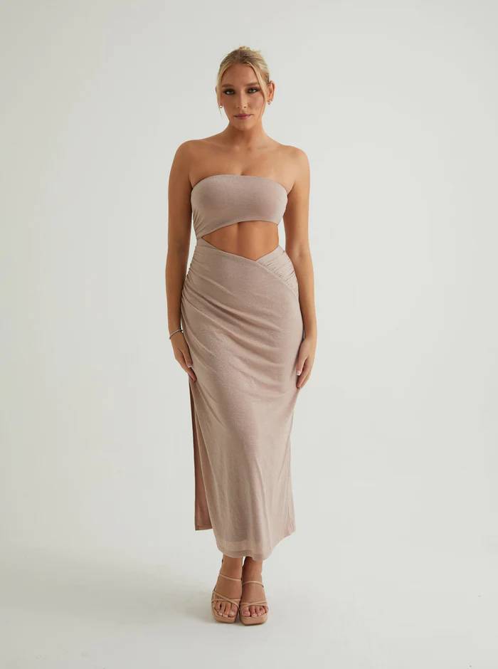 Woman wearing a sleeveless nude brown dress with waist cut-out